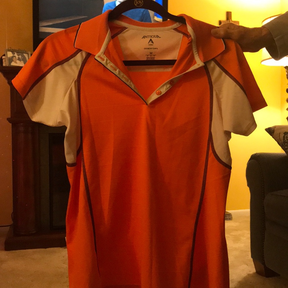 Orange, white and black golf tee